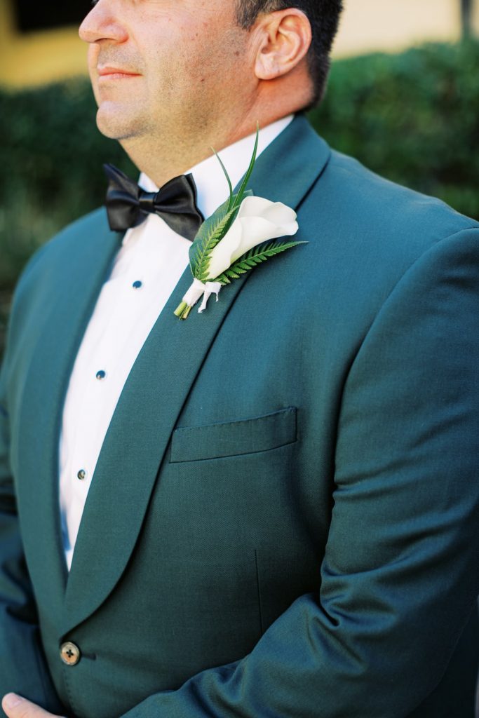 green grooms tuxedo with white boutonniere