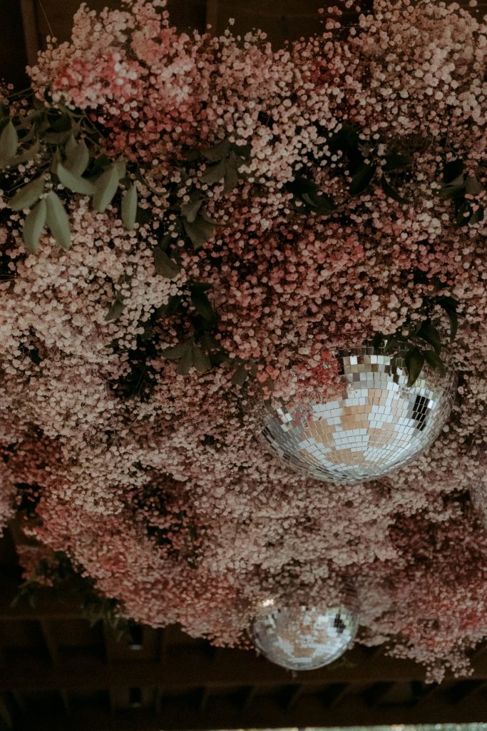 Pink floral installation above dance floor