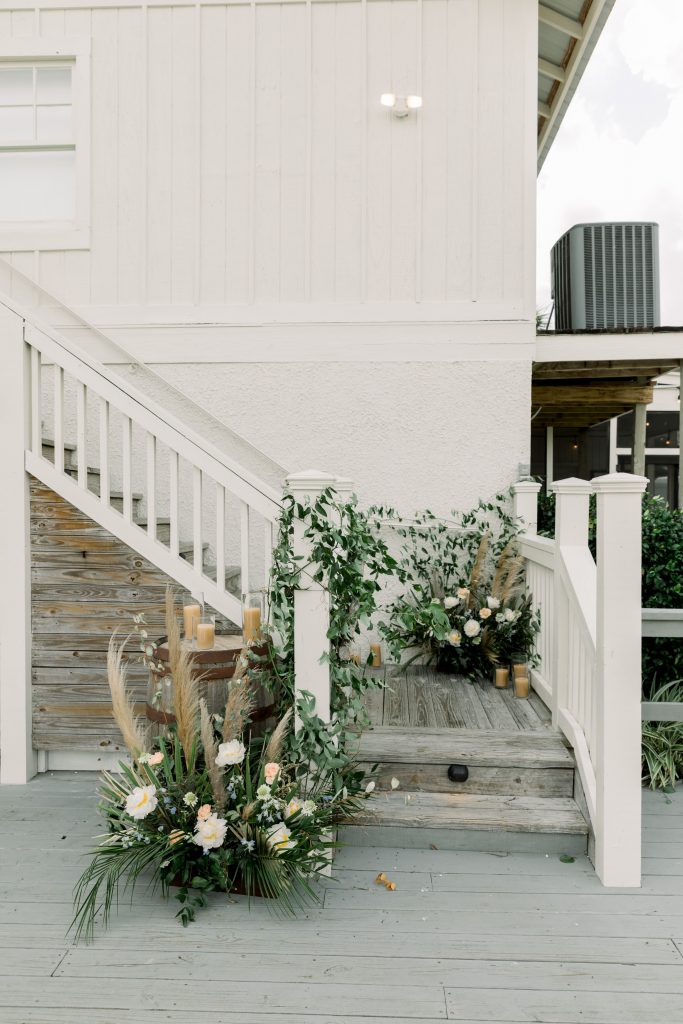 Floral arrangement with white and blue flowers and pampas grass