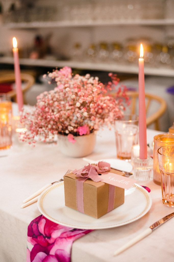 Pink table setting with pink flowers and pink candles