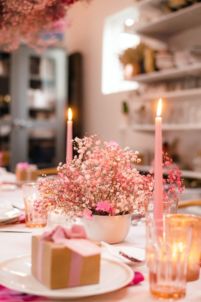 Pink table setting with pink flowers and pink candles