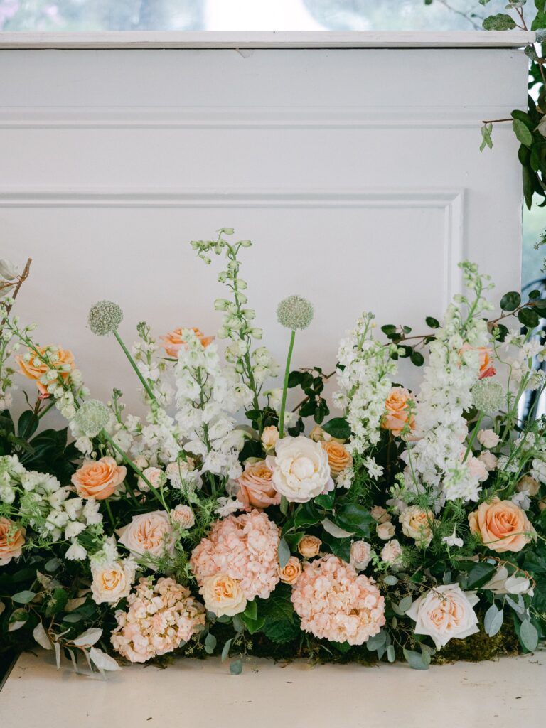 Peach and pink wedding flower arrnagements