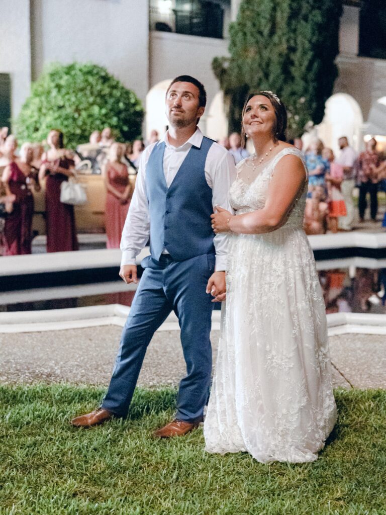 Bride and groom watching fireworks at wedding