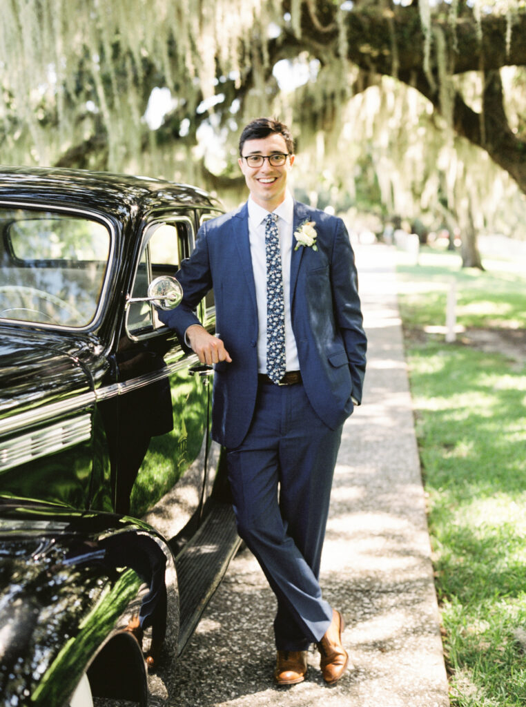 groom with vintage car