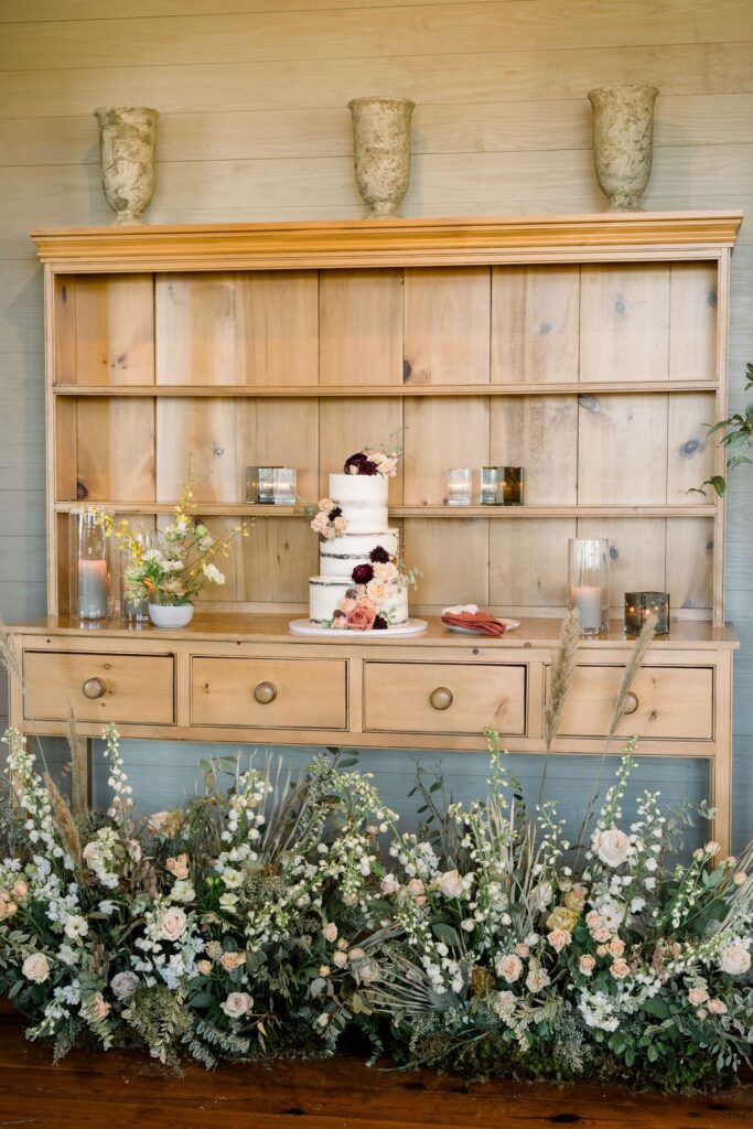 Wedding cake table with flowers underneath