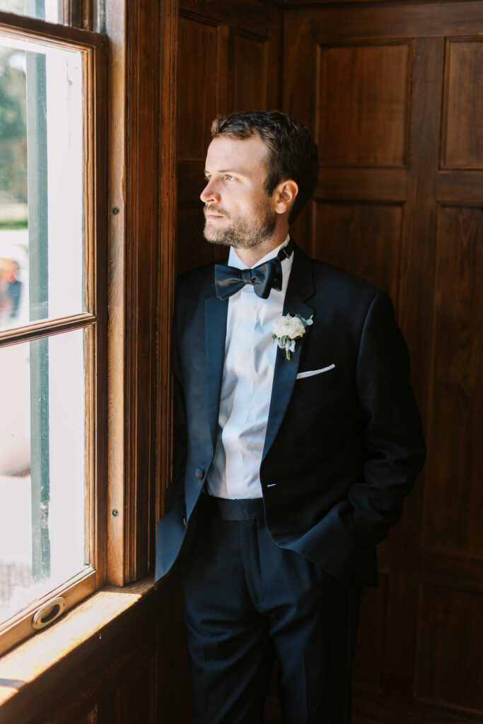 Groom looking out window