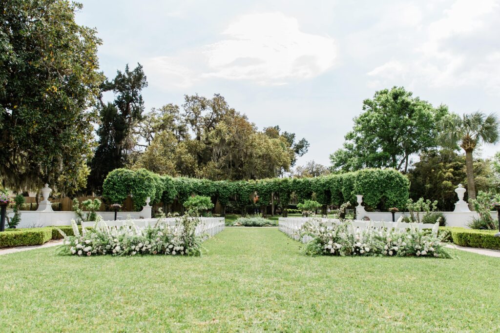 Jekyll Island Club Resort Wedding Ceremony with white flowers & white chairs
