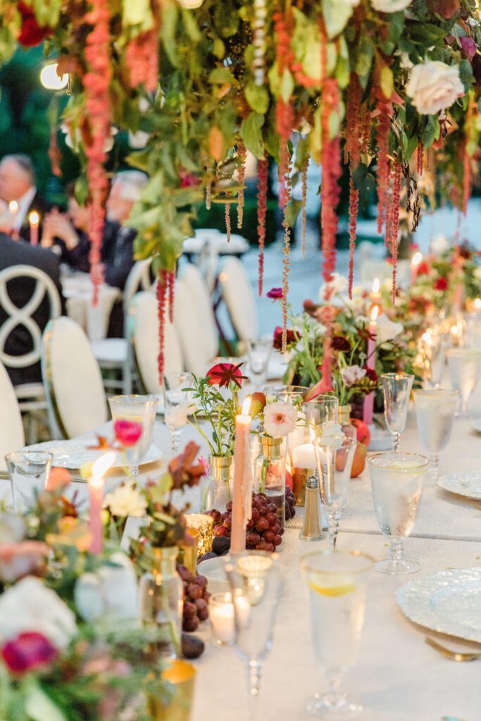 White wedding table with burgundy flowers