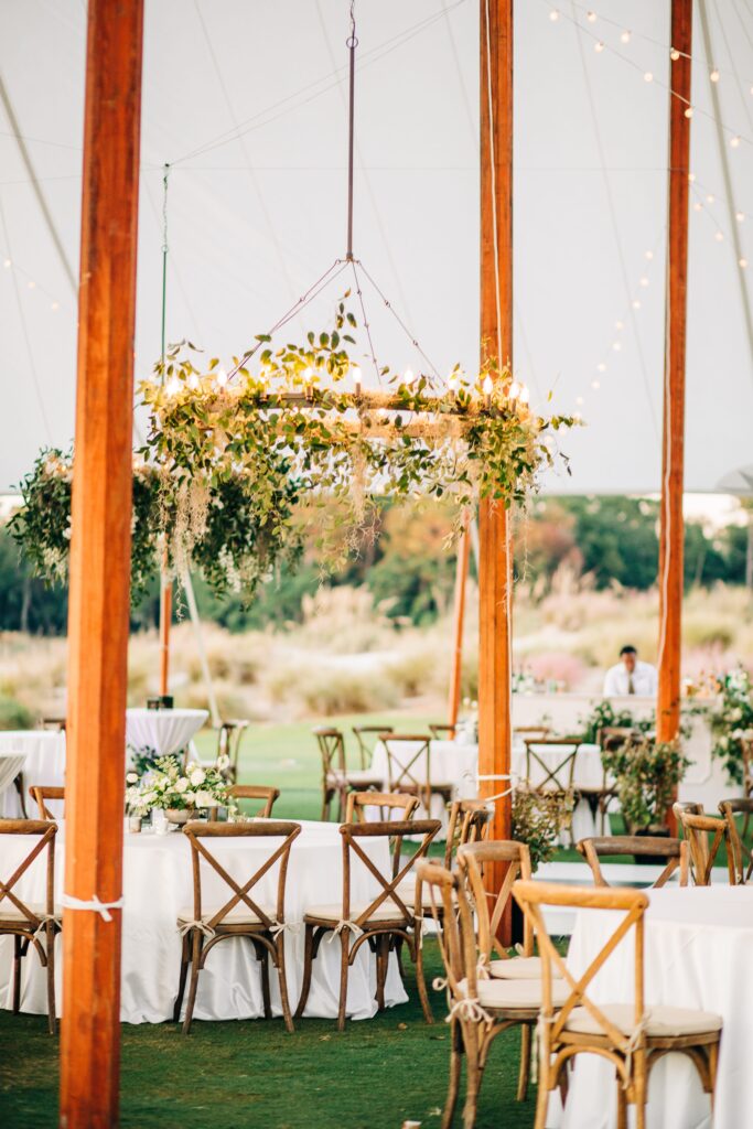 tented wedding reception at Colleton River Club with floral chandelier