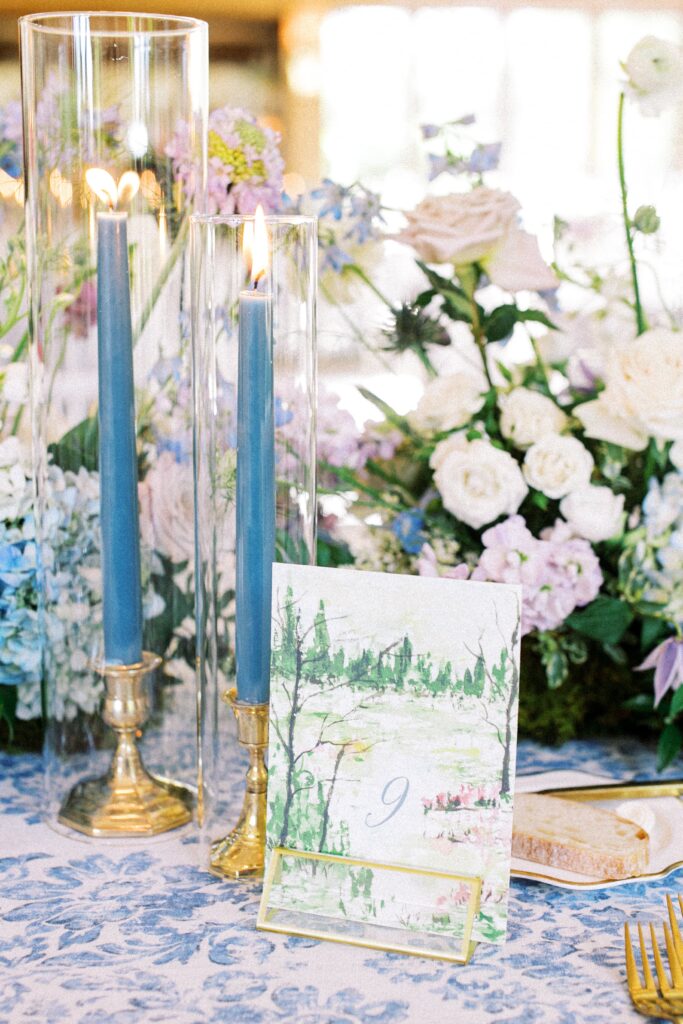Blue taper candles with watercolor table numbers